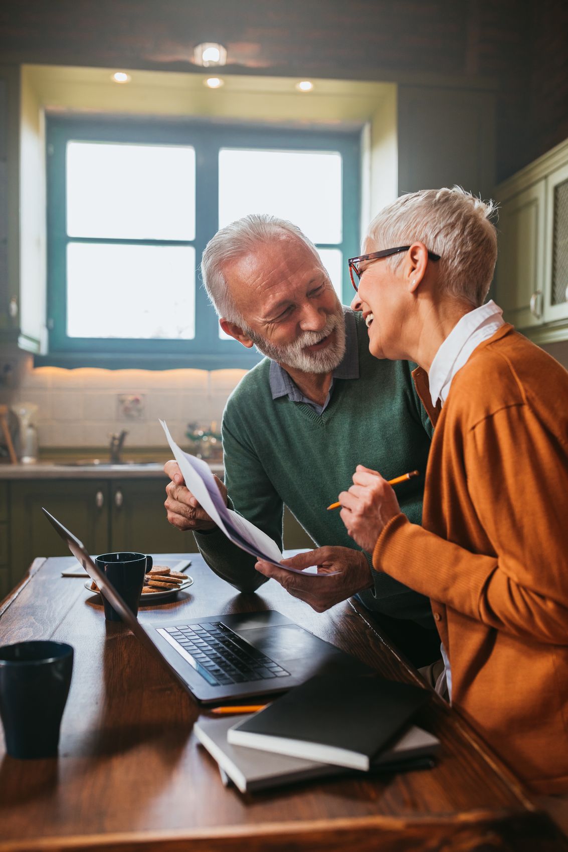 Older couple reviewing papers together at home
