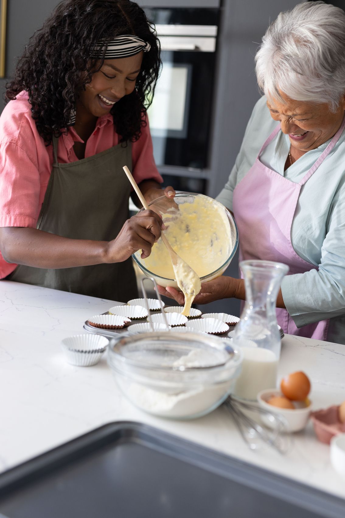 Two women baking together in a kitchen
